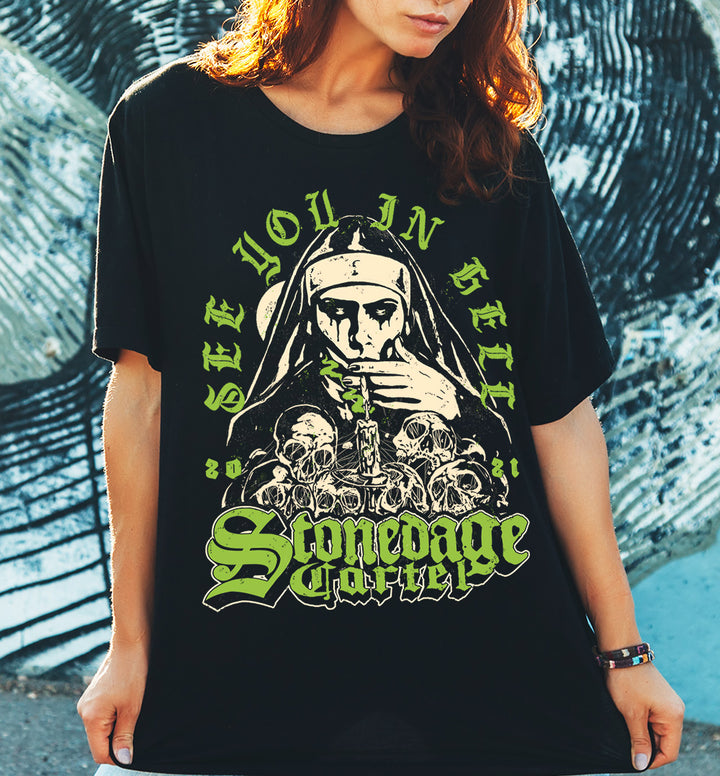 See You In Hell Unisex T-shirt, Nun Goth Smoking Weed on Pile Of Skulls Stonedage Cartel Clothing Brand.